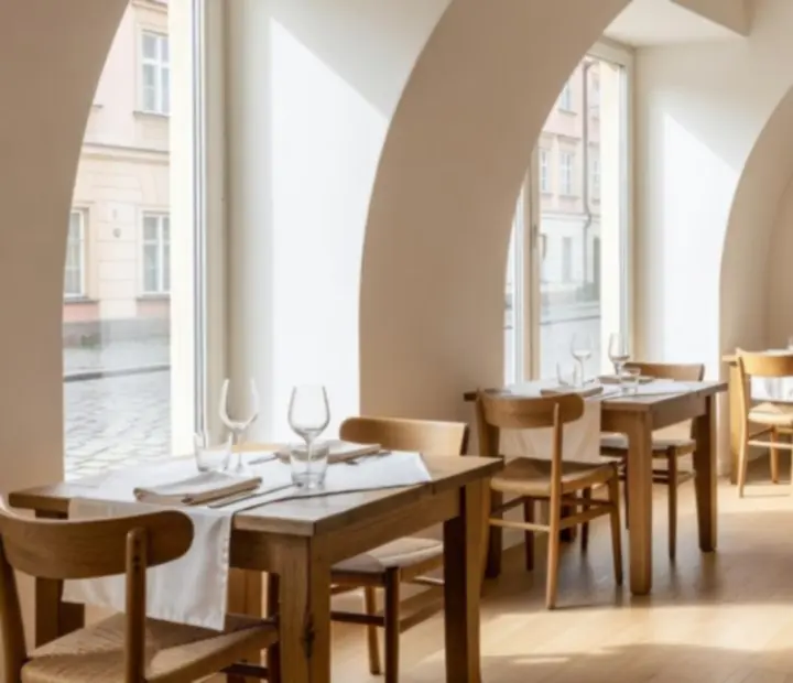 Sun-lit Cesstria bistro interior with rustic wooden tables and soft cream tones.